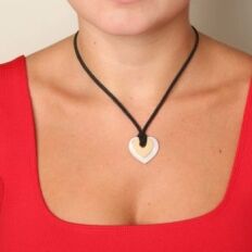 Poiray Coeur secret pendant worn on a mannequin