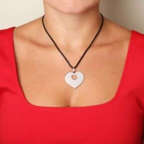 Poiray Coeur secret pendant worn on a mannequin