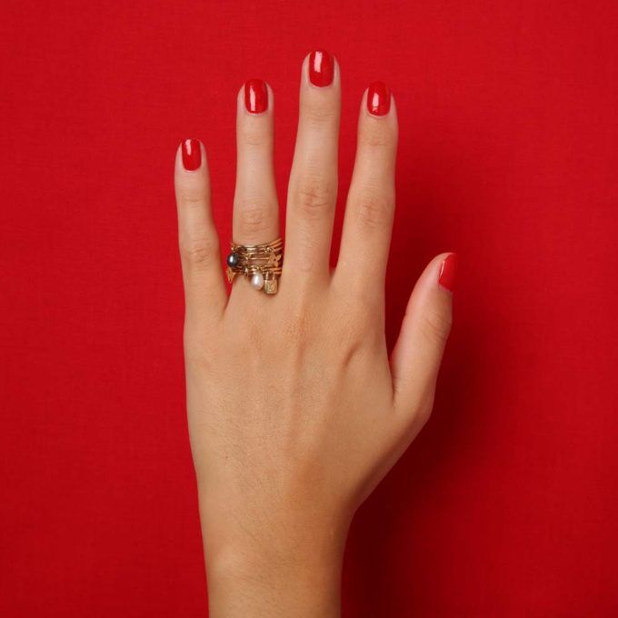 hand on red background with second hand Louis Vuitton ring