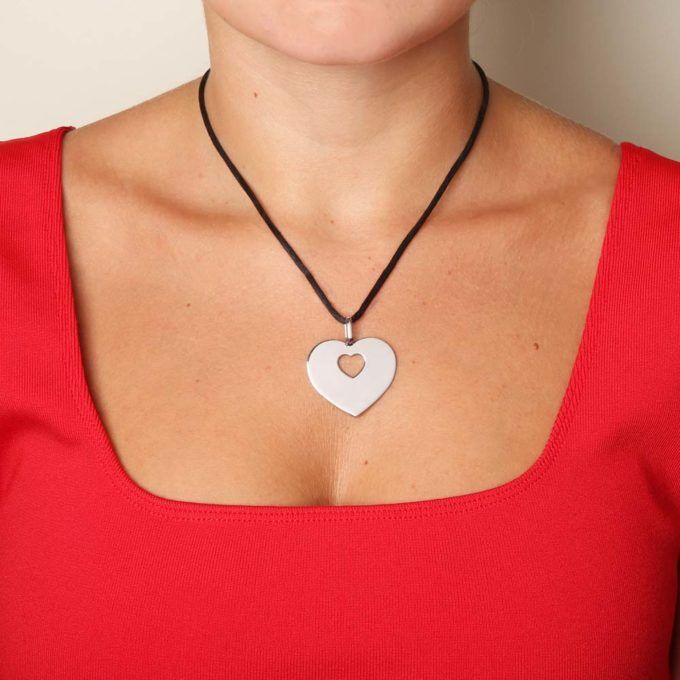 Poiray Coeur secret pendant worn on a mannequin