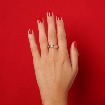 hand on red background with second hand Louis Vuitton ring
